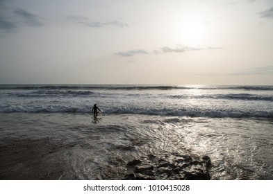 Surfer Going Into The Water.