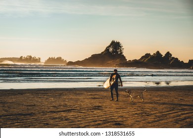 Surfer With His Dog On Cox Bay Beach, Tofino, British Columbia