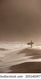 Surfer Holding Board In Sunset Beach Shore