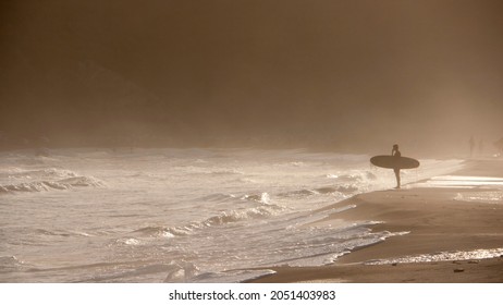 Surfer Holding Board In Sunset Beach Shore