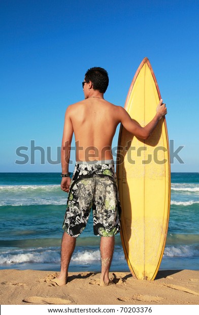 Surfer Holding Surf Board On Beach Stock Photo (Edit Now) 70203376