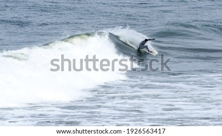 A Surfer jrides a wave at Westhaven State Park, Westport, Grays Harbor, Washington