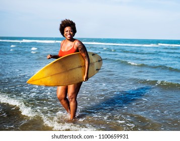 Surfer at a nice beach - Powered by Shutterstock