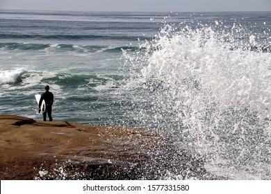 surfer observing the waves at Sunset Cliffs