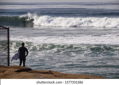 surfer observing the waves at Sunset Cliffs