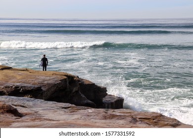 surfer observing the waves at Sunset Cliffs