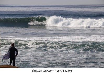 surfer observing the waves at Sunset Cliffs