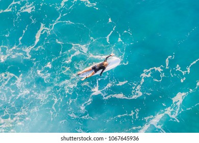 Surfer in the ocean, top view - Powered by Shutterstock