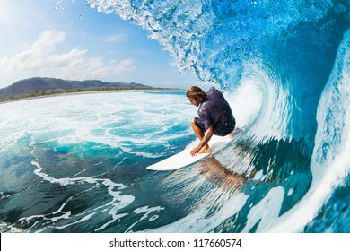 Surfer on Blue Ocean Wave in the Tube Getting Barreled