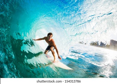 Surfer on Blue Ocean Wave in the Tube Getting Barreled