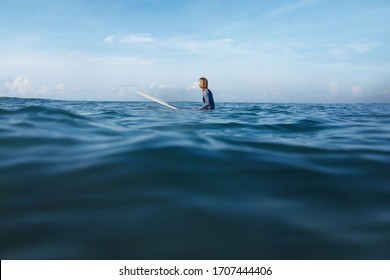 Surfer on Surf Spot. Young Man In Wetsuit On Surfboard Swimming In Ocean. Waved Seascape, Lifestyle Concept On Blue Sky With Soft Clouds Background.  - Powered by Shutterstock