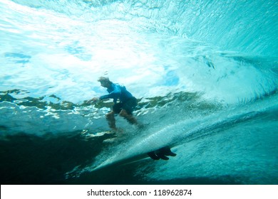 Surfer on tropical wave underwater vision