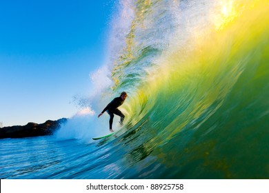 Surfer On Wave At Sunset