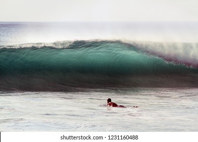 Surfer Paddling Out To Perfect Wave