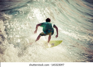 Surfer Rides A Large Blue Tropical Wave In Paradise