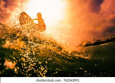 Surfer rides the ocean wave with lots of splashes. Extreme sport and action concept