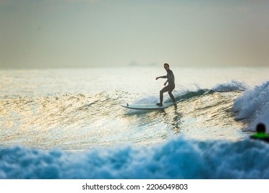 A Surfer Rides On The Crest Of A Big Wave With Foam At Sunset. Surfing Man. Extreme Water Sport Concept - 14 JUL 2015 Vladivostok Russia