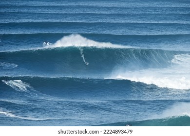 Surfer Is Riding A Giant Big Wave In Nazare, Portugal. Biggest Waves In The World. Touristic Destination For Surfing And Lovers Of Radical Sports. Jet Skis In The Water. Amazing Destinations. Nazare C