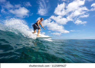 surfer riding on big waves on the Indian Ocean island of Mauritius - Powered by Shutterstock