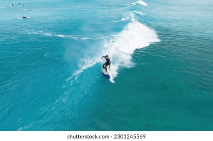 Surfer riding a wave in Hawaii - Powered by Shutterstock