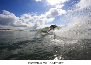 Surfer Riding A Wave In Sunny Weather. Australia