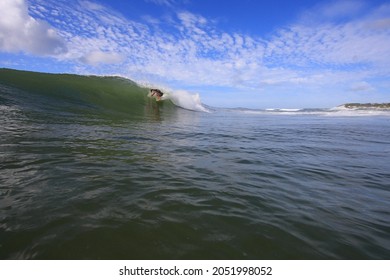 Surfer Riding A Wave In Sunny Weather. Australia