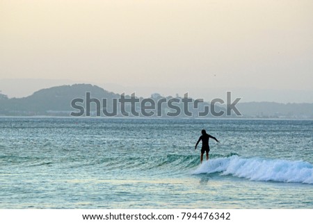 Surfer at sunset, Snapper Rocks