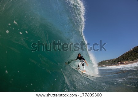 Surfer Surfing Crashing Wave Surfer surfing in pocket of crashing hollow wave, a water swim view of action