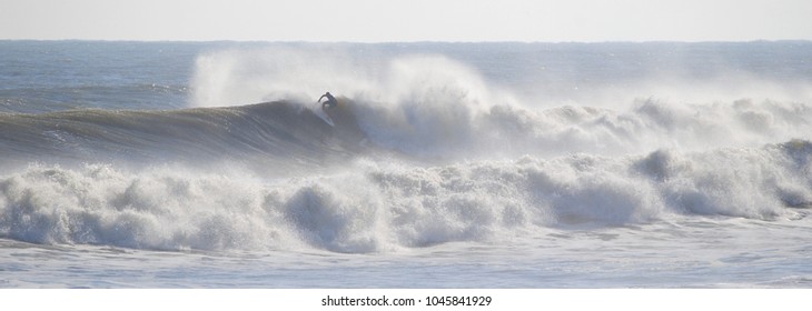 Surfer in violent waves