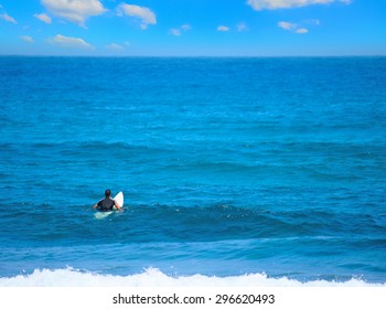 Surfer Waiting For The Wave Under A Huge Cloud