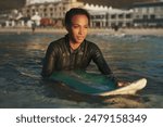 Surfer wetsuit, swimming and woman at sea for summer adventure, ocean activity and outdoor hobby. Female person, water and surfing board for sport vacation, wellness exercise and competition practice