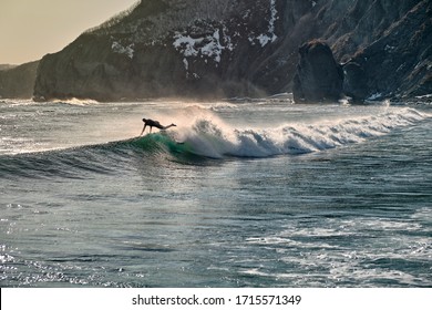 Surfer Wipeout With Waves And Spray Background. Aerial View Of Surfer Falling Off Surf Board At Sunset.