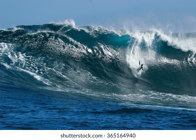 A surfer wipes out on a huge wave at renowned big wave surfing spot Dungeons in Cape Town, South Africa.