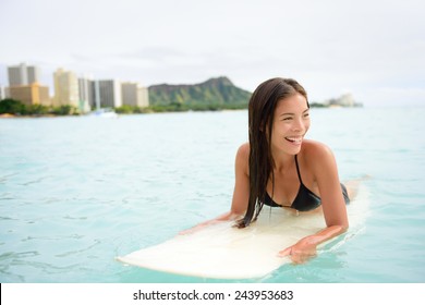 Surfer Woman Surfing On Waikiki Beach, Oahu, Hawaii. Female Bikini Girl On Surfboard Smiling Happy Living Healthy Active Lifestyle On Hawaiian Beach. Asian Caucasian Model.