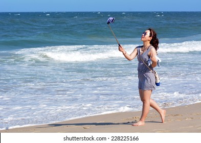 SURFERS PARADISE - NOV 01 2014:Young Adult Asian Woman Take Selfie Photo On The Beach. Over 1 Million Selfies Are Taken Each Day.Instagram Has Over 53 Million Photos Tagged With The Hash Tag #selfie.