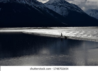 Surfers Ride The Famous Bore Tide Up The Turnagain Arm.