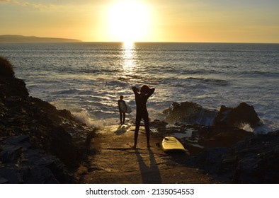 Surfers In Sunset, North Devon, UK 