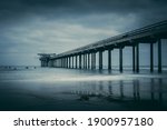 Surfers surfing next to Scripps Pier in La Jolla, long exposure . High quality photo