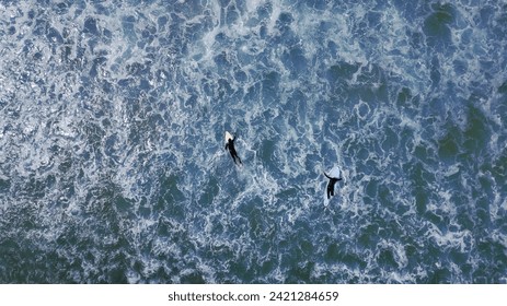 surfers waiting for a wave in the Atlantic Ocean on the coast of Portugal - Powered by Shutterstock