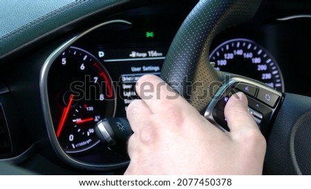 Surfing in Additional car control instruments on car dashboard using modern sensor button on the wheel.