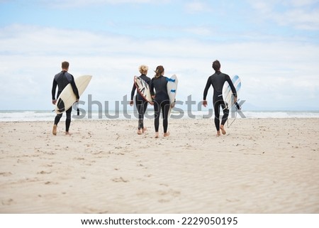 Similar – Image, Stock Photo Surfers on the beach go to the sea