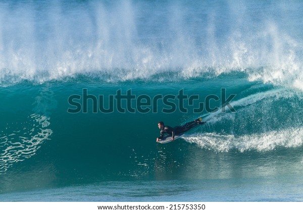 Surfing Body Boarding Inside Wave\
Surfing rider body boarding inside large hollow ocean\
wave