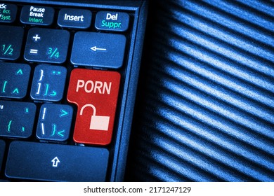 Surfing the Internet unlocking pornography concept showing red computer key marked Porn with copy space.