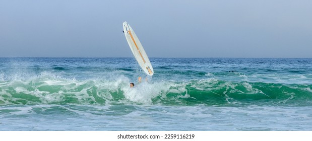 surfing on the sea in waves - Shutterstock ID 2259116219