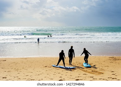 Surfing School Learning Taking Surf Lesson At The Beach. Portugal