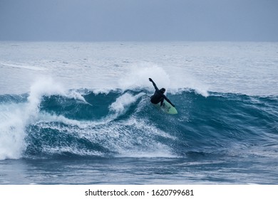 Surfing At Unstad Beach In Lofoten Islands. Arctic Surf