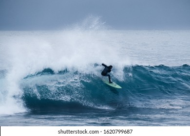 Surfing At Unstad Beach In Lofoten Islands. Arctic Surf