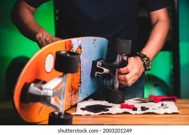 Surfskate maintenance and repair concept. Technician repairing the surfskate. - Powered by Shutterstock