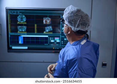 Surgeon analyzing data on screen during procedure