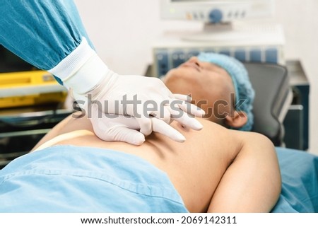 surgeon and assistant making CPR on the patient in the operating room. First Aid Emergency- Cardiopulmonary resuscitation